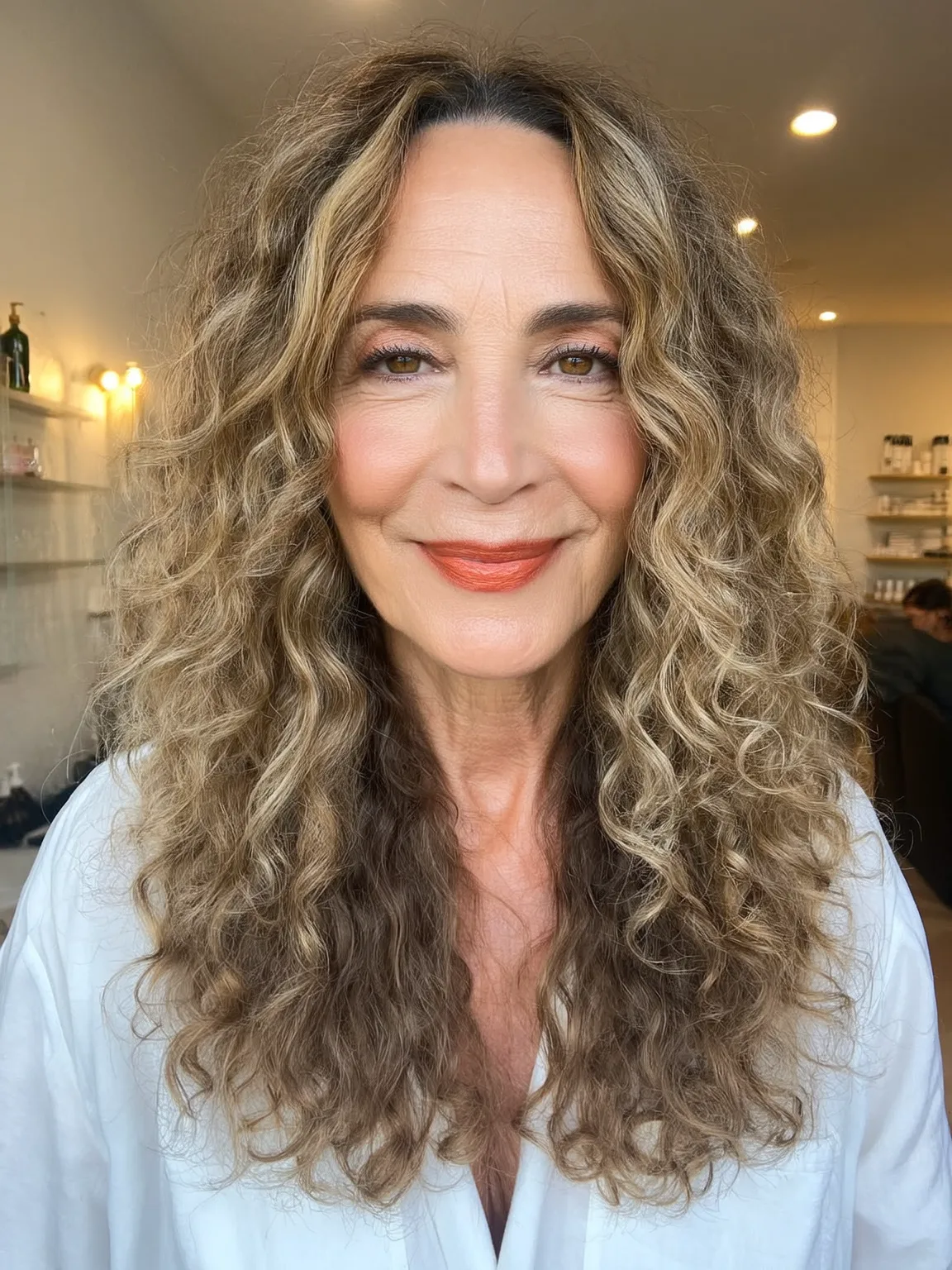Long Layered Curly Hairstyle in Caramel Blonde with Lowlights